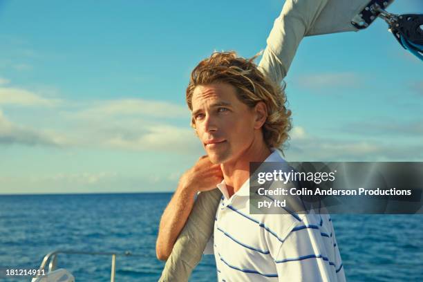 caucasian man standing on sailboat - blonde hair man stock pictures, royalty-free photos & images