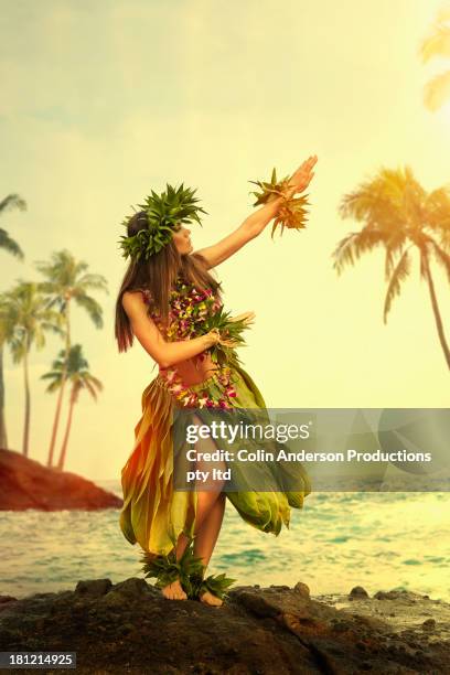 pacific islander woman performing traditional dance on rocky beach - lei day hawaii stock-fotos und bilder
