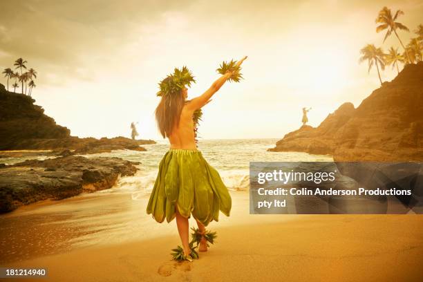 pacific islander woman performing traditional dance on rocky beach - honolulu culture stock pictures, royalty-free photos & images