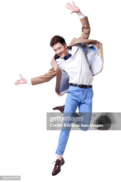 stylish businessman jumping with excitement - pekín express fotografías e imágenes de stock