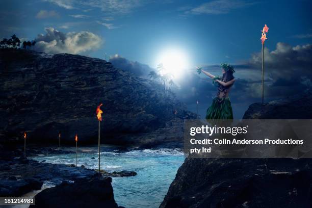 pacific islander woman performing traditional dance on rocky beach - lens flare young people dancing on beach stock pictures, royalty-free photos & images