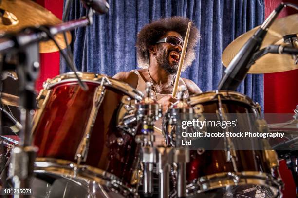 mixed race drummer performing - baterista fotografías e imágenes de stock