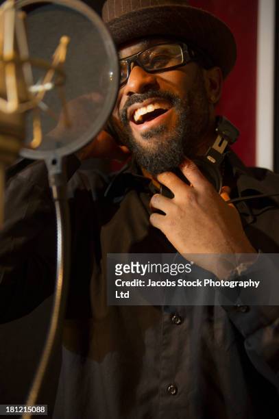 mixed race singer recording in studio - microphone mouth stock pictures, royalty-free photos & images