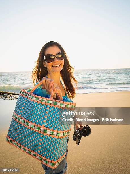 mixed race woman walking on beach - tote bag stock pictures, royalty-free photos & images