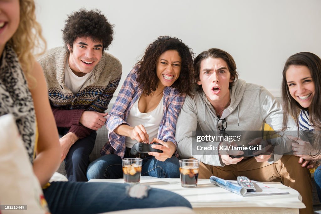 Friends playing video games in living room