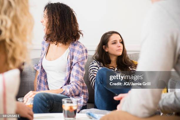 friends relaxing in living room - exclusive foto e immagini stock