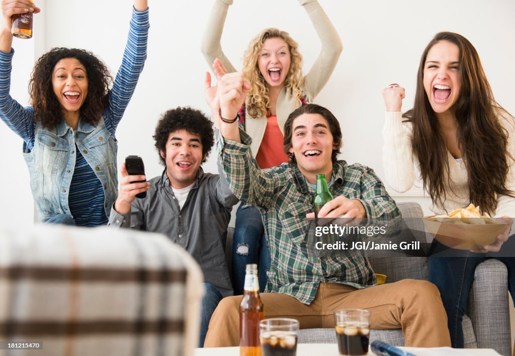 Friends cheering in living room