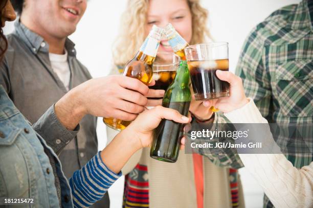 friends toasting each other at party - holding cold drink stock pictures, royalty-free photos & images