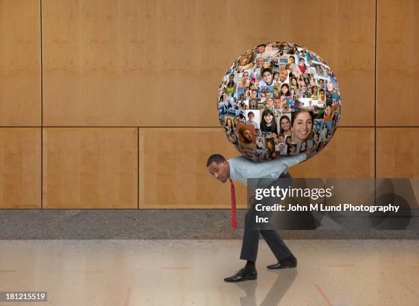 businessman carrying globe on his back - big world stock pictures, royalty-free photos & images