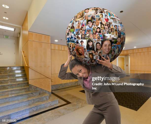 businesswoman carrying globe on her back - schwer stock-fotos und bilder