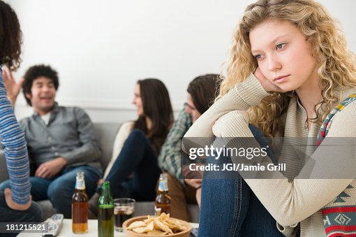 Woman sitting apart from friends Woman sitting apart from friends