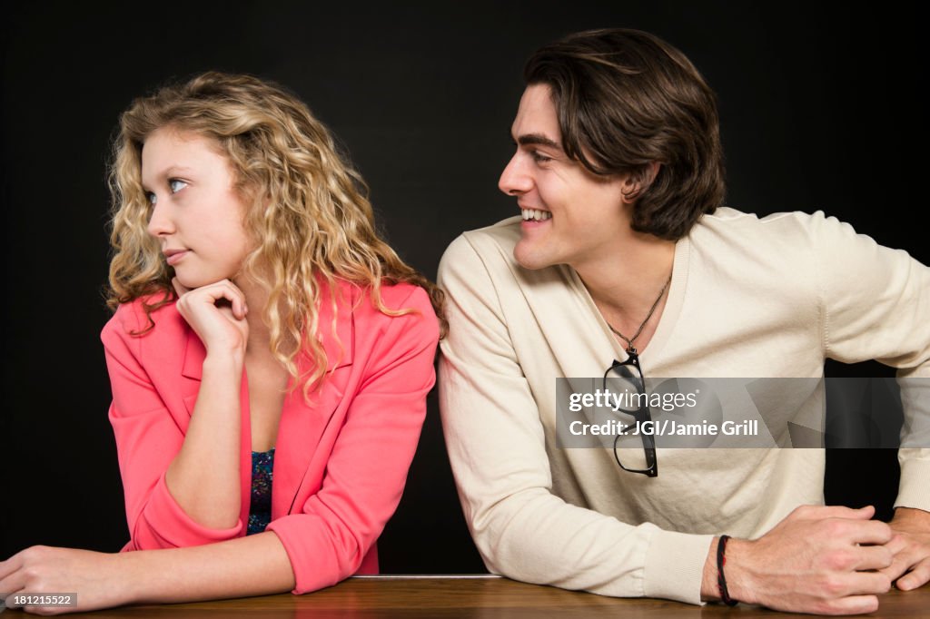 Man talking to uninterested woman