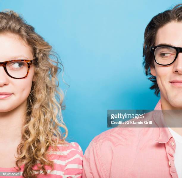 couple wearing eyeglasses - sideways glance stock pictures, royalty-free photos & images