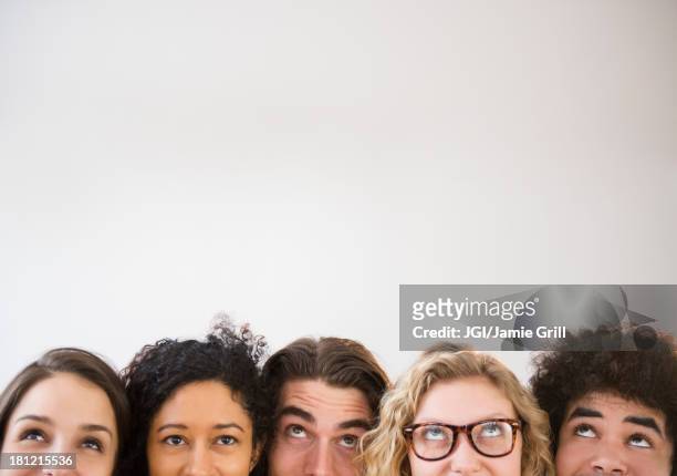 friends looking up - group people thinking stock pictures, royalty-free photos & images