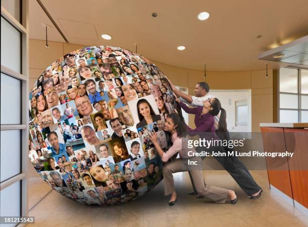 businesspeople carrying globe on their backs - man with big balls stock pictures, royalty-free photos & images
