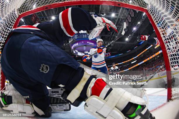 Ryan Nugent-Hopkins of the Edmonton Oilers knocks the puck out of the air to score a goal on goalie Charlie Lindgren of the Washington Capitals...