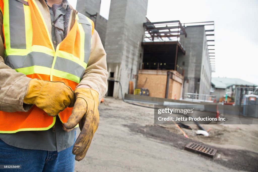 Workers pulling on gloves on site