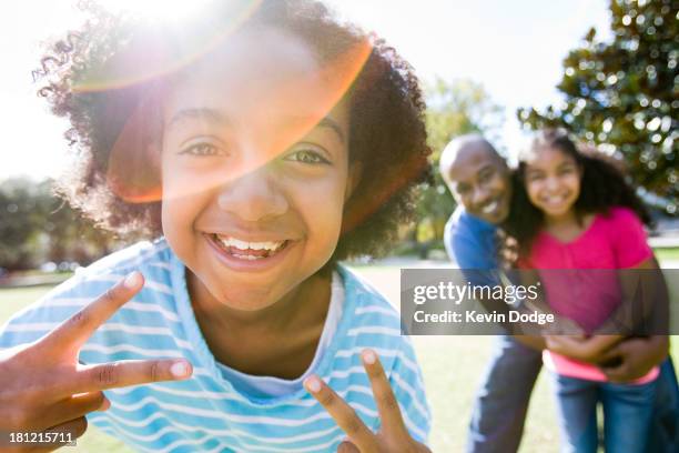 father and daughters smiling in park - orlando florida family stock pictures, royalty-free photos & images