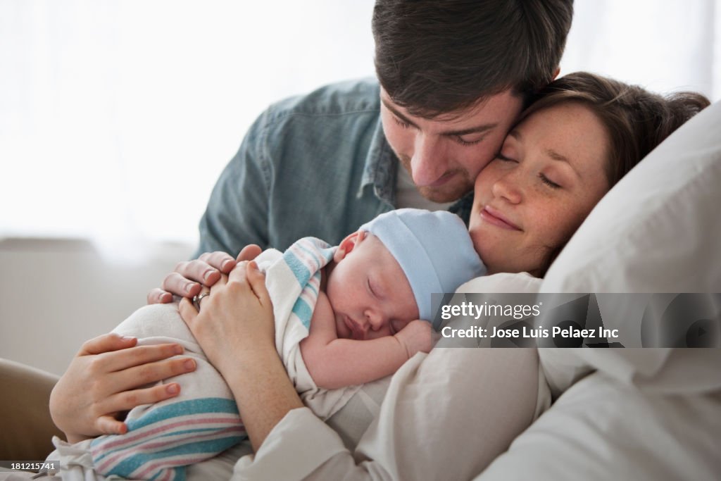 Caucasian couple holding baby