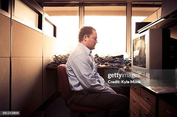 caucasian businessman watching television at desk - loneliness work stock pictures, royalty-free photos & images