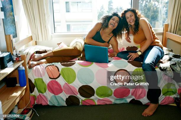 mixed race college students laughing in dorm - college dorm stock pictures, royalty-free photos & images