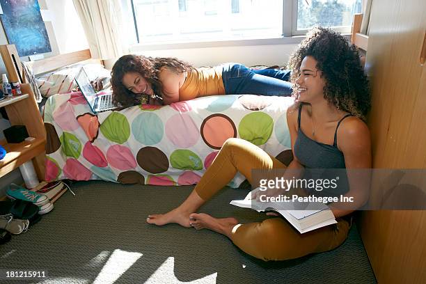 mixed race college students relaxing in dorm - college dorm stock pictures, royalty-free photos & images