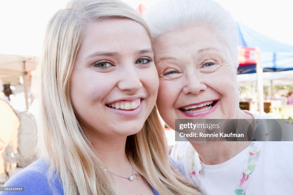 Caucasian woman smiling with granddaughter