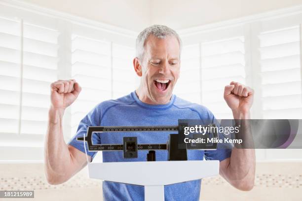 caucasian man weighing himself - lehi stock pictures, royalty-free photos & images