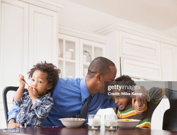 father kissing sons at breakfast table - farewell in 2012 stock pictures, royalty-free photos & images