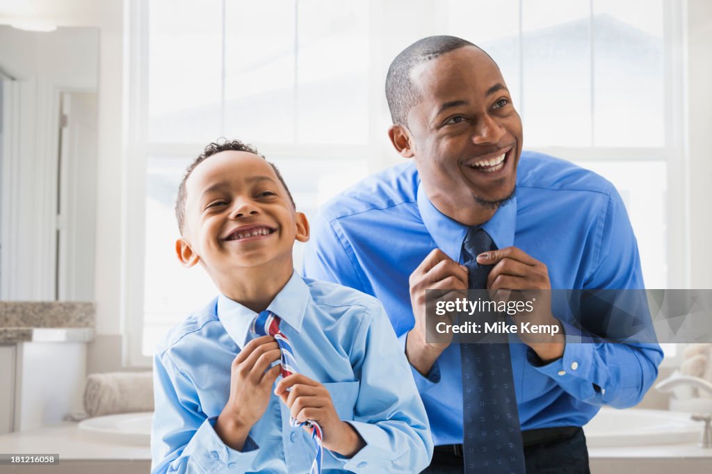 Father and son straightening their ties