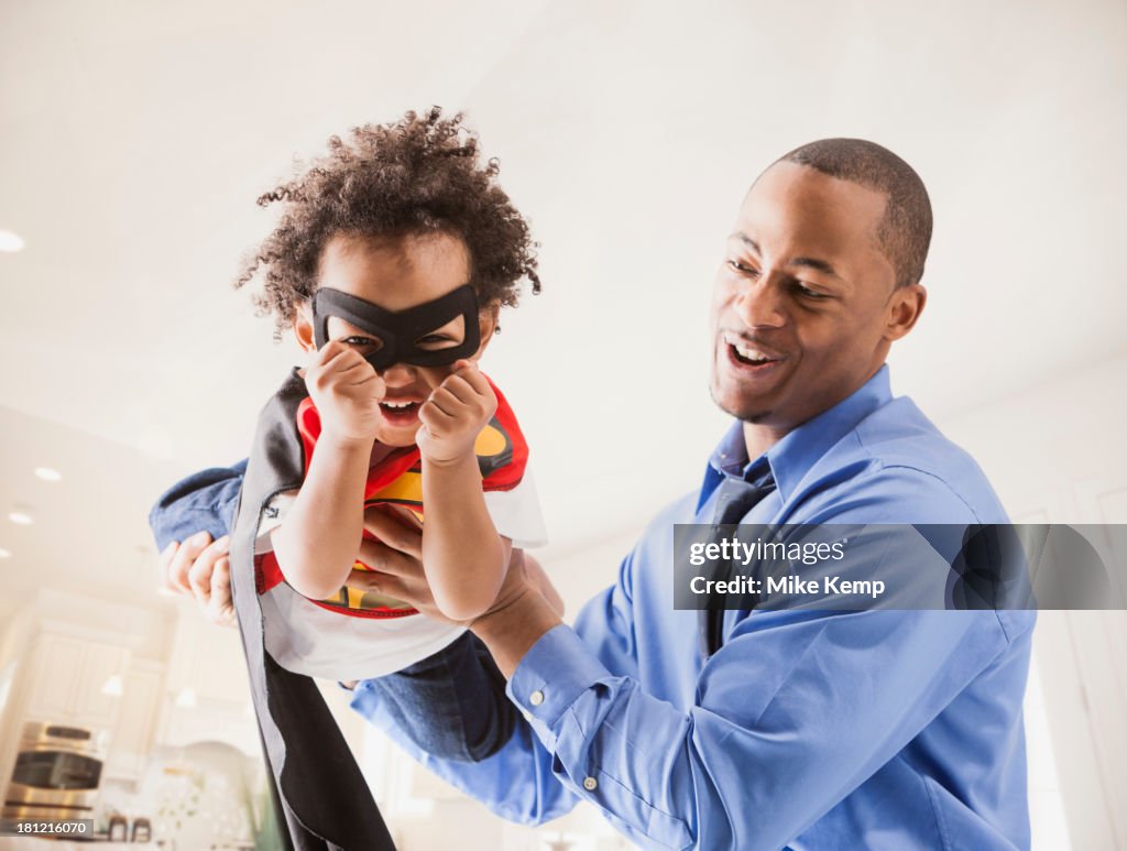 Father and son playing superhero