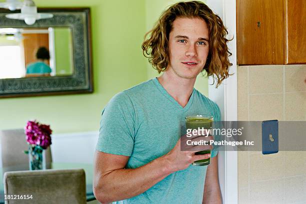 caucasian man having glass of juice - holding cold drink stock pictures, royalty-free photos & images