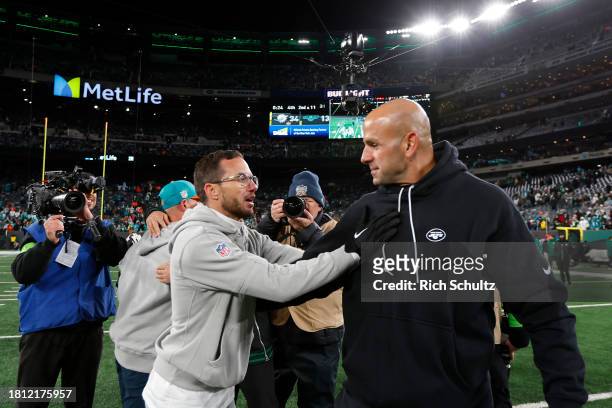 Head coach Robert Saleh of the New York Jets congratulates head coach Mike McDaniel of the Miami Dolphins after the game at MetLife Stadium on...