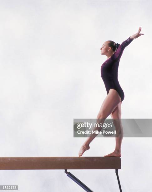 Model/Property Released: Female teenage gymnast beginning routine on balance beam
