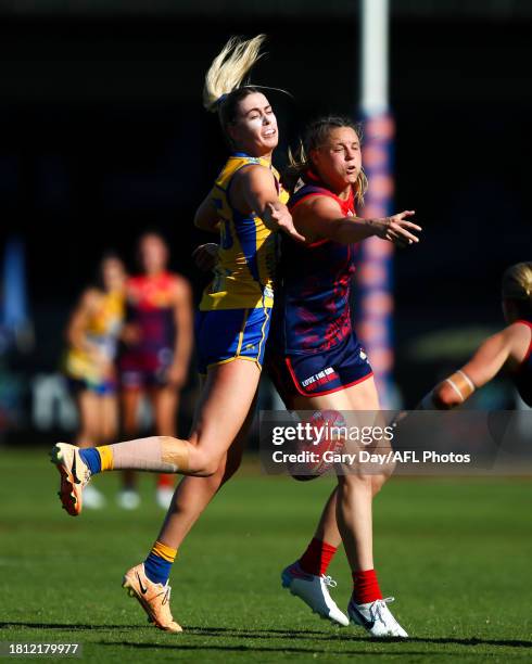 Eleanor Hartill of the Eagles and Rhiannon Watt of the Demons compete in a ruck contest during the 2023 AFLW Round 07 match between the West Coast...