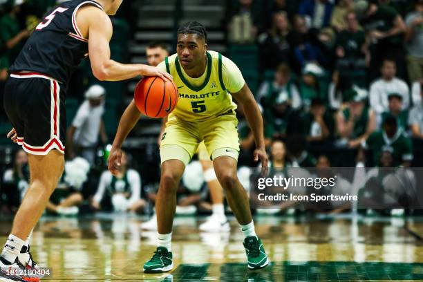 Isaiah Folkes of the Charlotte 49ers defends Grant Huffman of the Davidson Wildcats during the Battle for the Hornets' Nest at Dale F. Halton Arena...