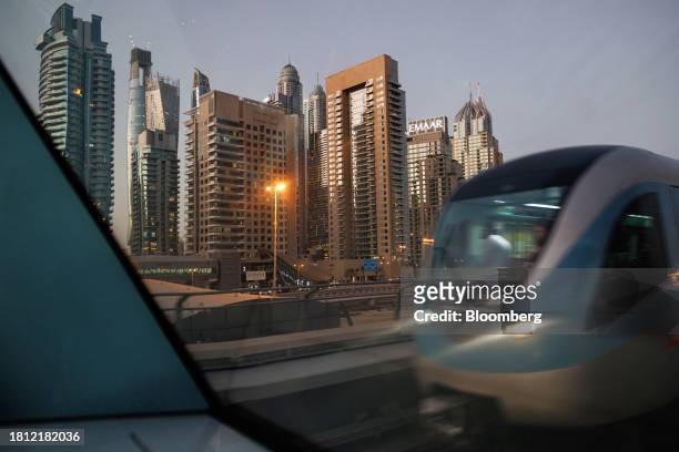 Metro train travels past skyscraper office buildings in Dubai, United Arab Emirates, on Wednesday, Nov. 29, 2023. More than 70,000 politicians,...