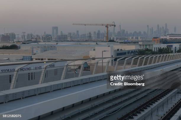 Construction crane, backdropped by skyscrapers on the city skyline in Dubai, United Arab Emirates, on Wednesday, Nov. 29, 2023. More than 70,000...