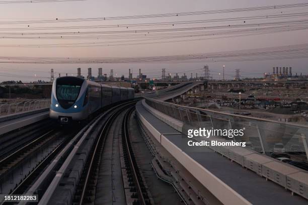 Metro train travels under electricity power cables in Dubai, United Arab Emirates, on Wednesday, Nov. 29, 2023. More than 70,000 politicians,...