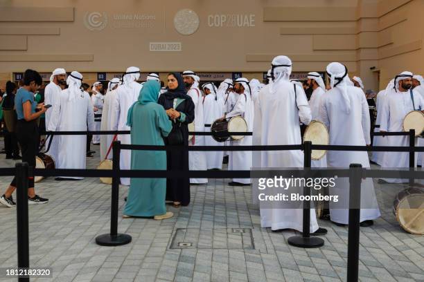 Traditional drumming band from Ras Al Khaimah queue to enter the Blue Zone ahead of the COP28 climate conference at Expo City in Dubai, United Arab...