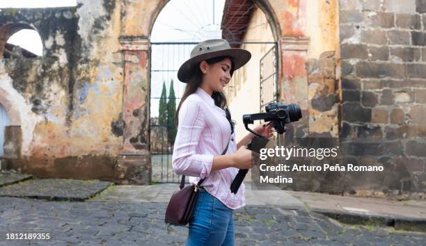 content creator with a gimbal in hand - content creation stock pictures, royalty-free photos & images