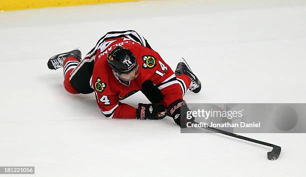 Drew LeBlanc of the Chicago Blackhawks hits the ice trying to control the puck against the Pittsburgh Penguins during an exhibition game at United...