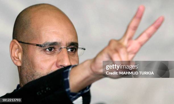 Seif al-Islam Kadhafi, son of Libyan strongman Moamer Kadhafi, flashes the V sign during a meeting with youths on March 10, 2011 in Tripoli, after he...