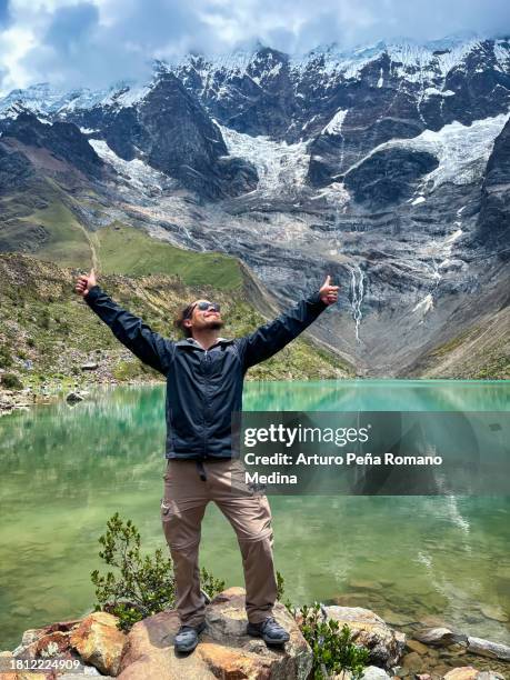 a man enjoying his visit to the humantay lagoon in cusco. - voyage zen stock pictures, royalty-free photos & images