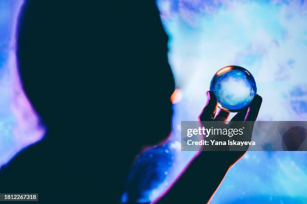 an imaginary image of an astronaut holding a small copy of a planet in outer space - rover stock pictures, royalty-free photos & images