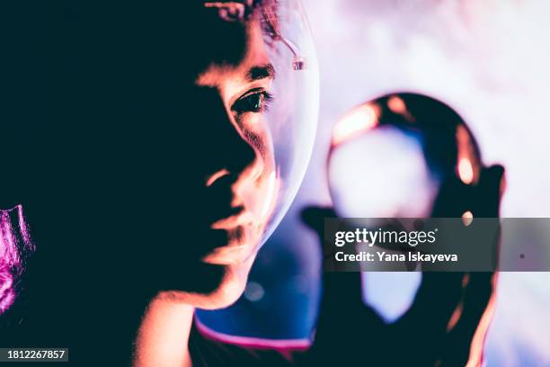 an imaginary image of an astronaut holding a small copy of a planet in outer space - rover stock pictures, royalty-free photos & images