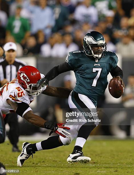 Quarterback Michael Vick of the Philadelphia Eagles attempts to break free from linebacker Akeem Jordan of the Kansas City Chiefs during the fourth...