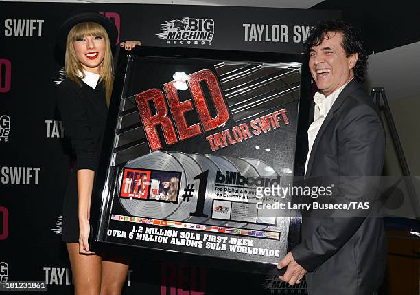 Taylor Swift is honored by Big Machine Label Group President and CEO Scott Borchetta for her multi-platinum album RED at a special event during the...