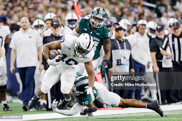 Nicholas Singleton of the Penn State Nittany Lions is tackled by Angelo Grose of the Michigan State Spartans in the second quarter of a game at Ford...