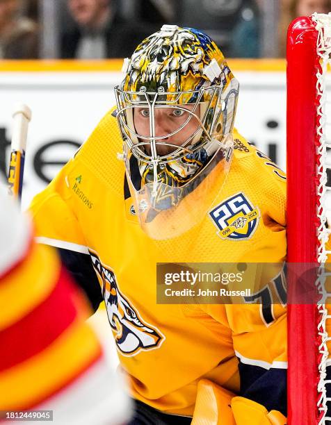 Juuse Saros of the Nashville Predators tends net against the Calgary Flames during an NHL game at Bridgestone Arena on November 22, 2023 in...